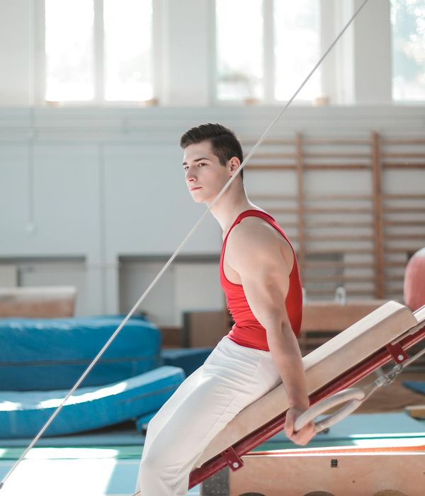 Athletic man in a focused pose during a strength workout.